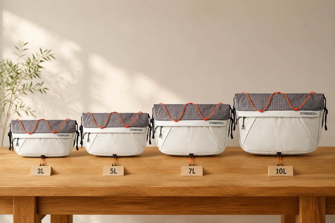 StormCrew ROAM bags lined up on a wooden table, comparing each sling bag size from 3L to 10L.