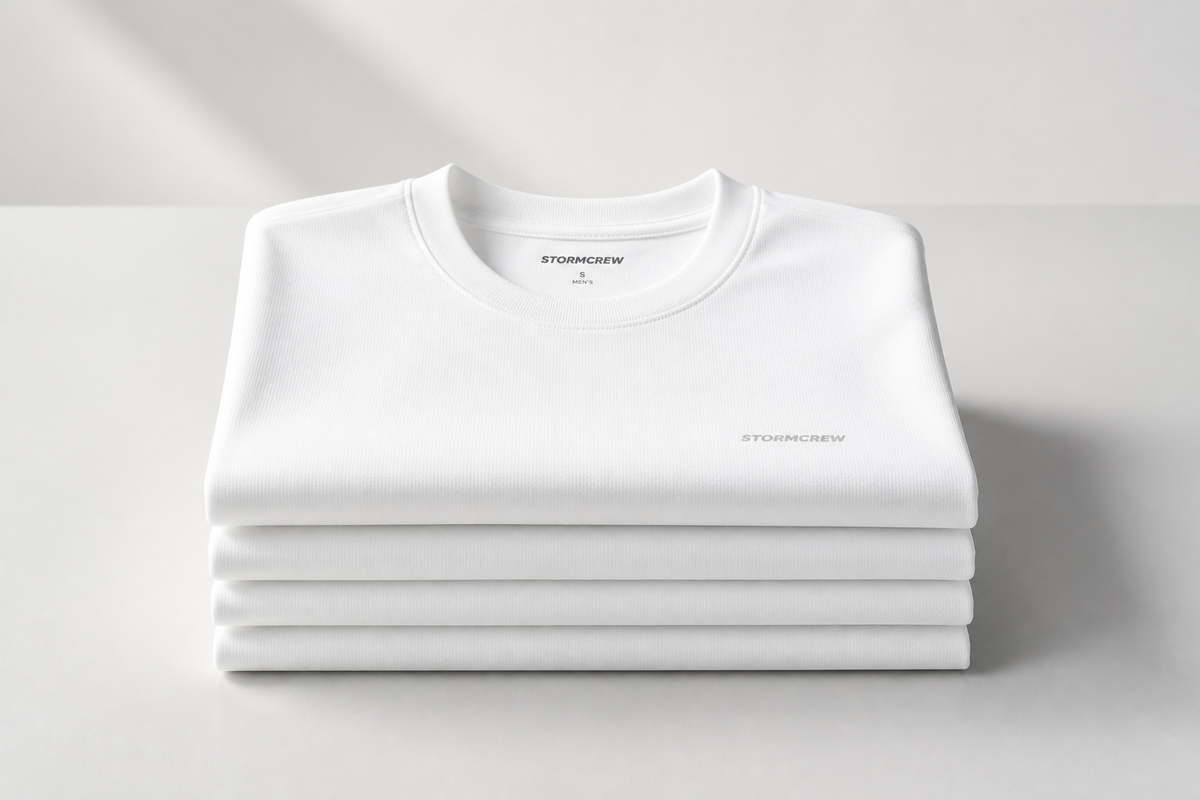 Neatly stacked white antibacterial shirts showcased in a minimalist setting with soft ambient lighting.