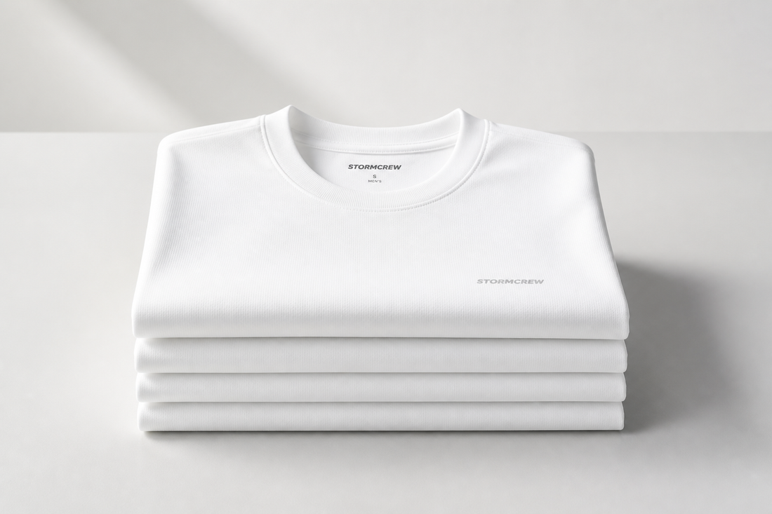 Neatly stacked white antibacterial shirts showcased in a minimalist setting with soft ambient lighting.
