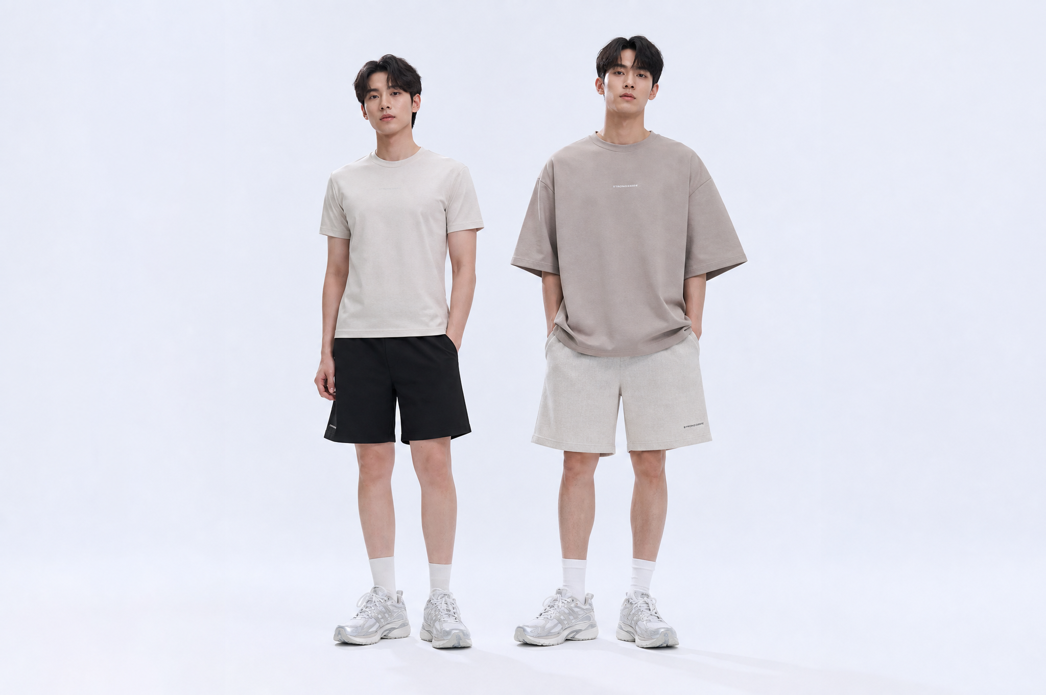 Two men in clean everyday outfits compare oversized vs regular fit basics with simple tees and shorts