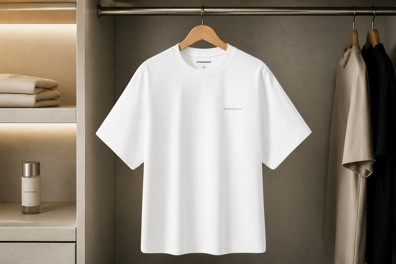Elegant white cooling quick dry t-shirt hanging on a wooden hanger in a minimalist wardrobe.